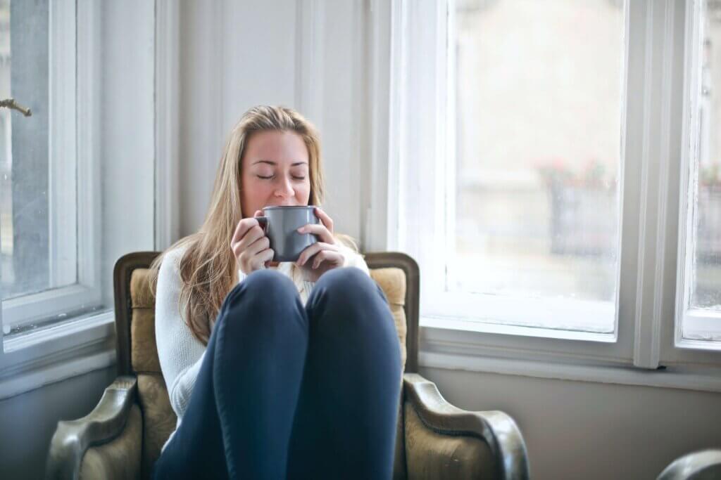 mental health in the workplace young woman relaxed driking a cup of tea
