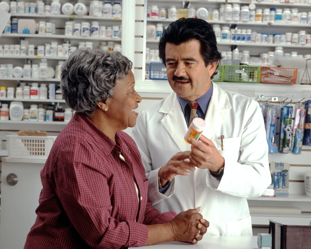 Pharmaceutical Labeling Translations and Patient-Centricity: a pharmacist explains a pharmaceutical label to a patient.