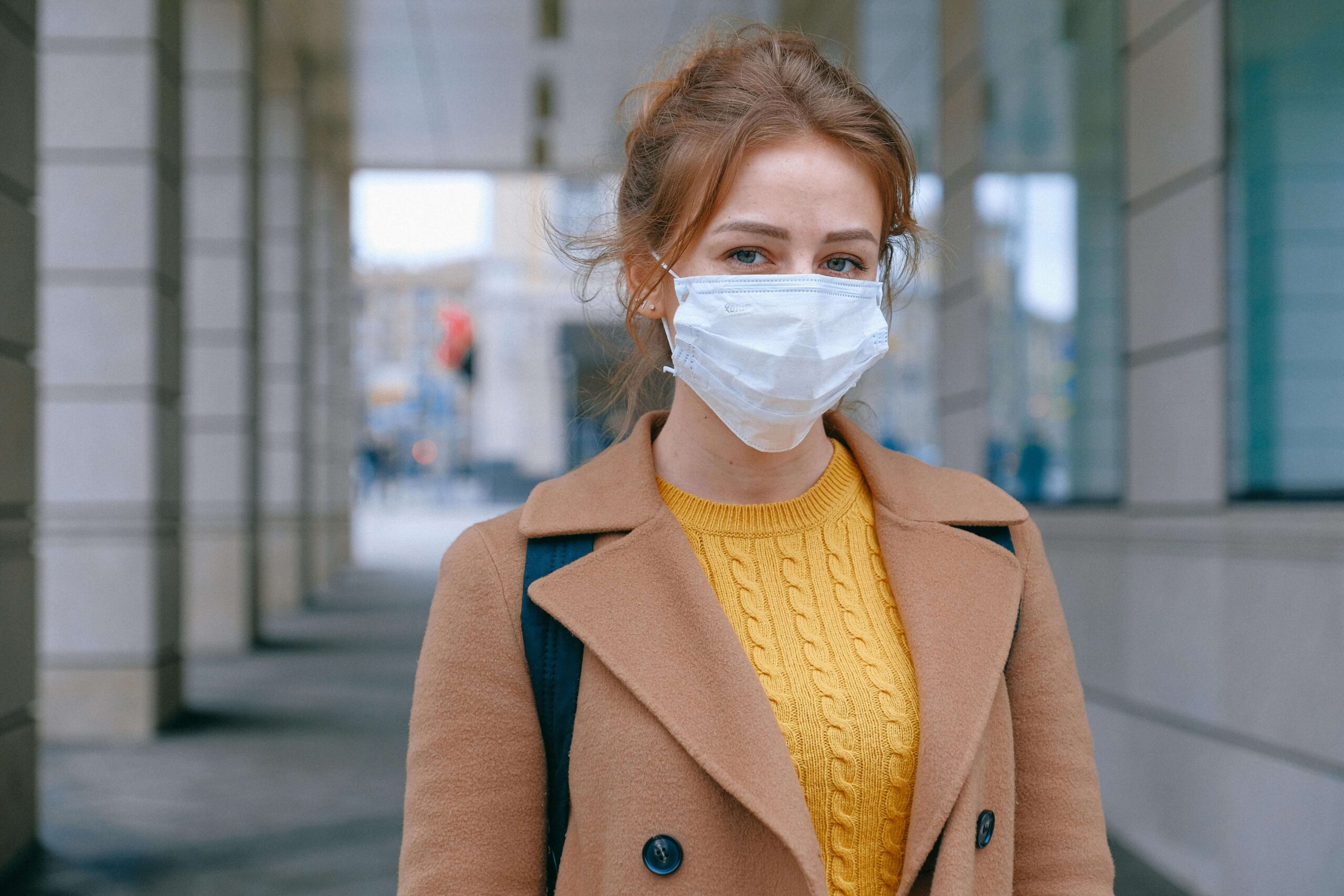 medical translation services: a woman wearing a facemask looks at the camera